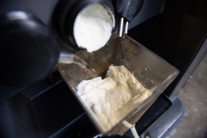 Auf diesem Detailfoto ist das Anmischen von Milchpulver und Wasser im CalfExpert zu sehen.