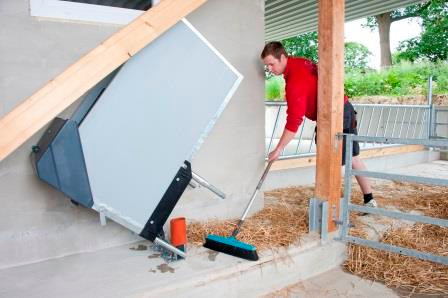 This picture shows a folded-up HygieneStation. The floor beneath is being swept.